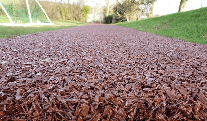 A bonded rubber mulch pathway