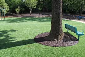 Tree well cover bound with bonded rubber mulch